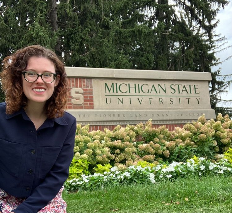 Theresa Murphy, standing outside by the Michigan State University sign.