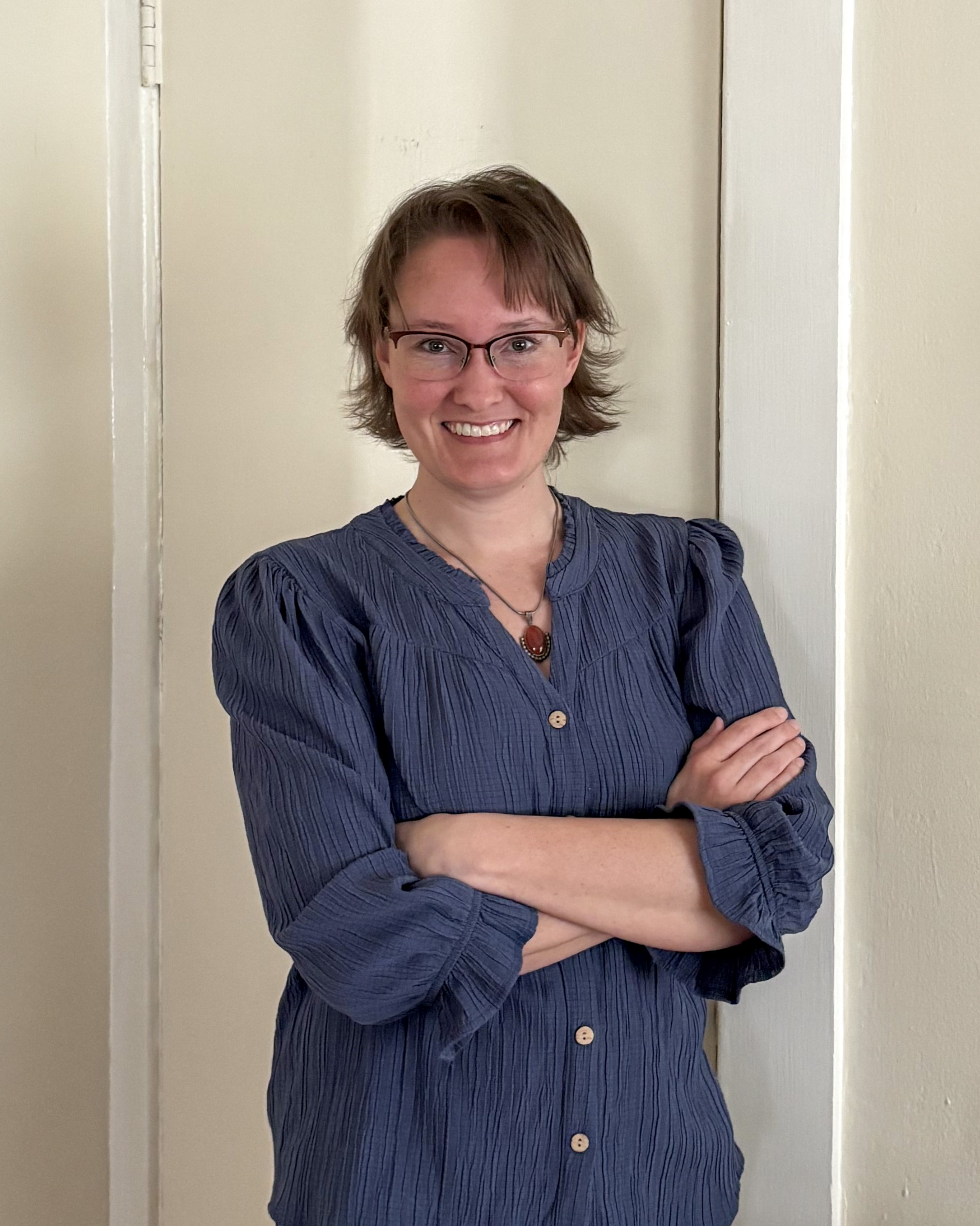Educator of the Month Imari Cheyne Tetu wearing a blue shirt againt a neutral background.