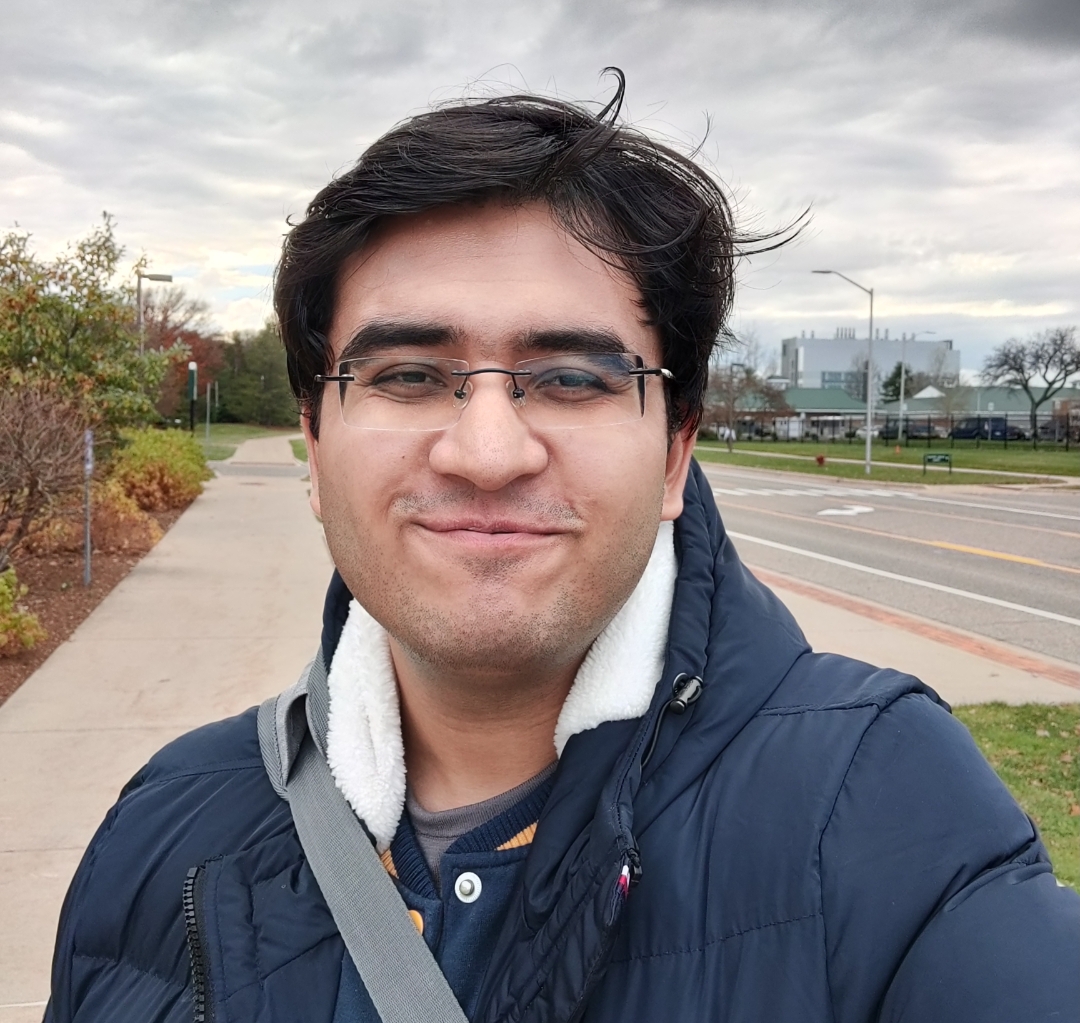Ritesh standing outside in a blue coat.