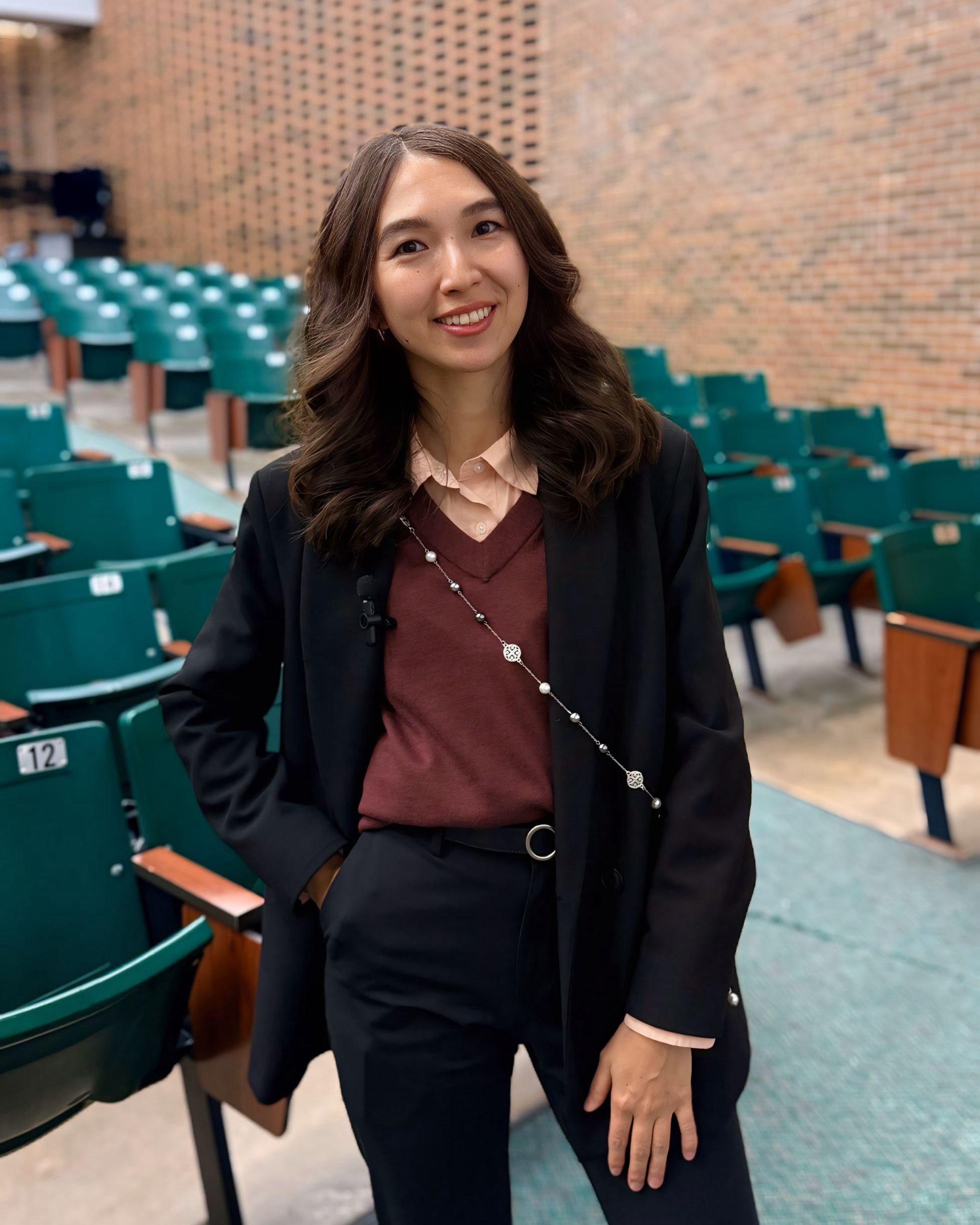 Educator of the Month Moldir Moldagaliyeva Educator of the Month Moldir Moldagaliyeva standing in an empty classroom.