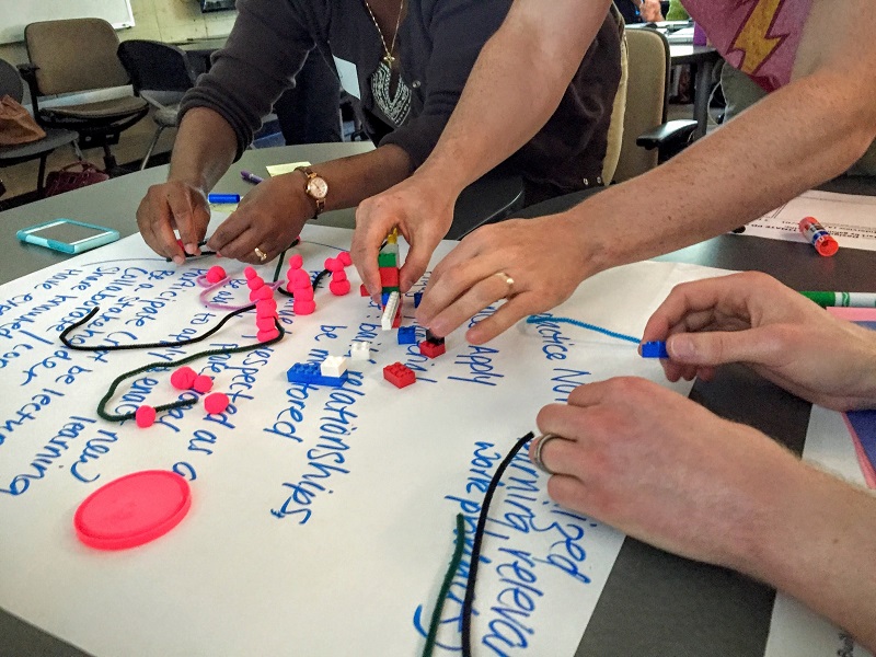 three people working on a project on a table