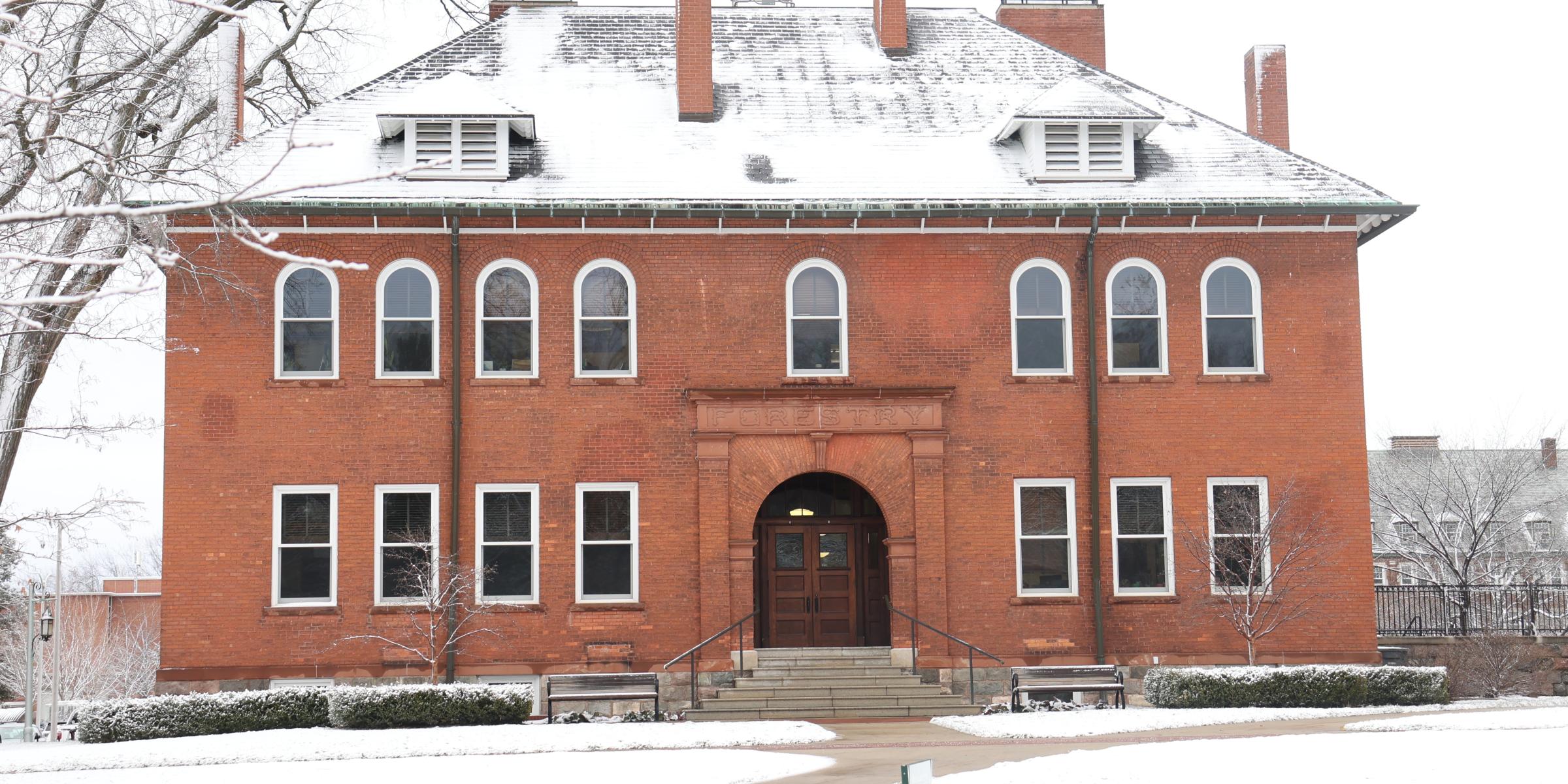A red brick building on a snowy morning.