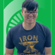 Educator of the Month Bobicheng (Beau) Zhang in front of a green background with the Spartan helmet.