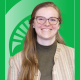 Educator of the Month Sophie Buysse in front of a green background with the Spartan helmet.